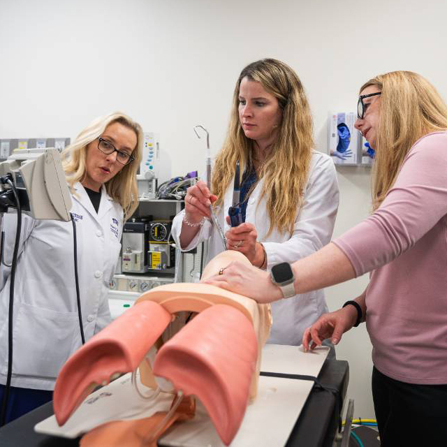 nursing student in simulation lab observing a monitor 