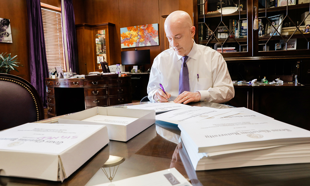 Chancellor Boschini signs diplomas